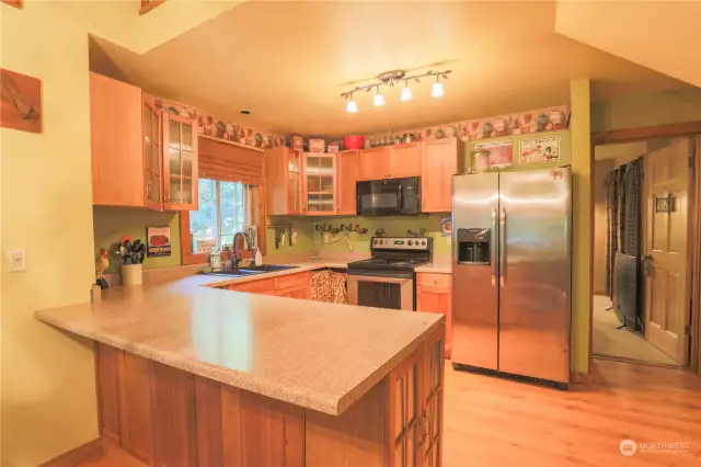 Kitchen, with a full size refrigerator, dishwasher, oven and large sink.