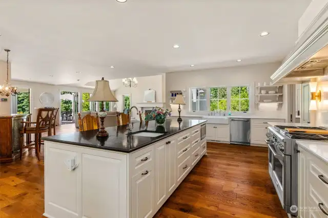 Gourmet kitchen is an entertainer's delight.  The enormous island is a gathering place for certain.  Hand crafted vent hood over Monogram stove, custom built-in spice cabinets and quartz counters.