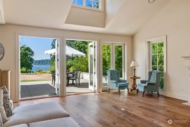 Four sets of French doors flank the Westerly side of the living room unifying the outside with the inside.