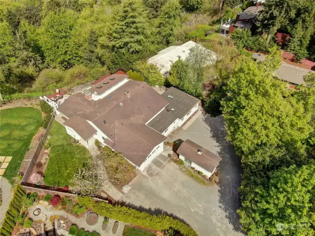 A drone view showing the massive size of this property with storage shed, attached double garage, and all the amenities under those roofs...providing true comfort for daily living!