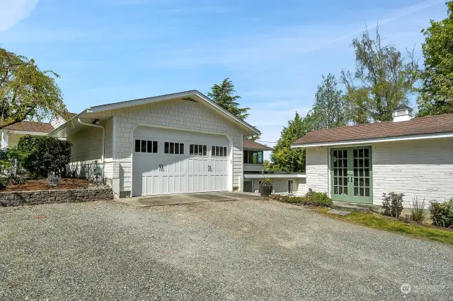 A closer view of this private property with gravel driveway up to the ridge the home sits on. The elegant shed to the right is perfect for garden supplies. As you can see, parking is NOT a problem here. Send out those invitations...this is a home unmatched for livability and entertaining!