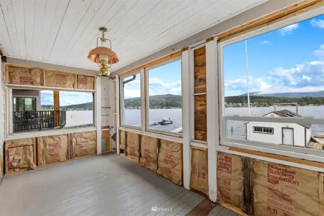 The enclosed sunroom is in need of finishing and has stunning lake and foothill views.