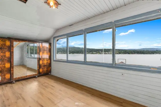The upstairs sunroom have wood lined ceilings and walls and incredible views.