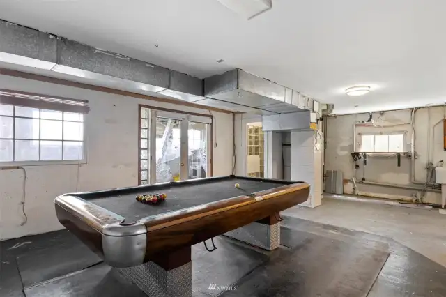 There is a pool table in the basement as well as a 3/4 bath.