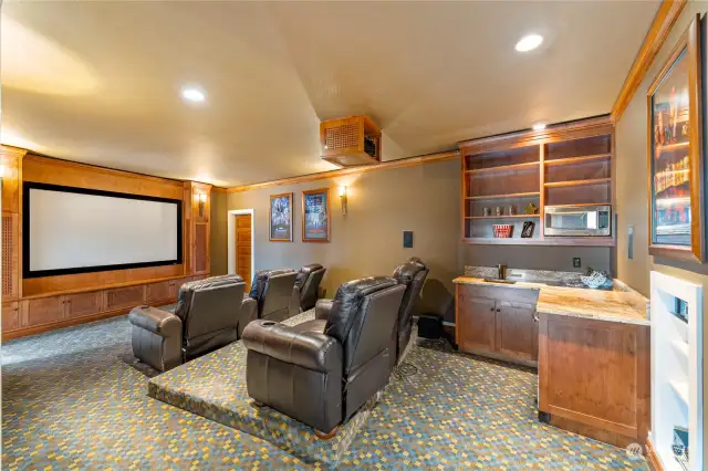 Dedicated Theatre Room with wet bar, refrigerator, dishwasher, microwave and shelving. Movie nights galore!