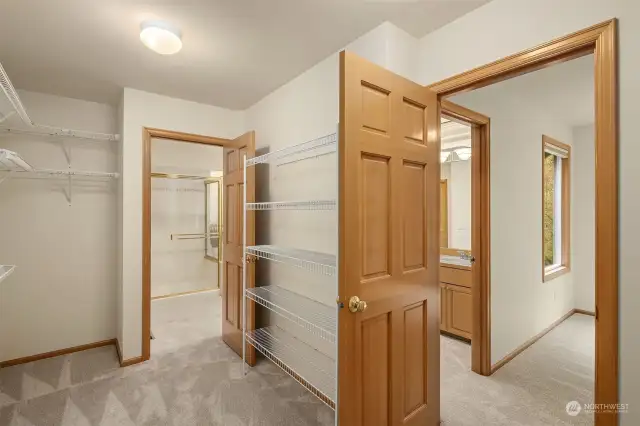 Convenient walk-through closet providing ample storage space with a motion sensor light.