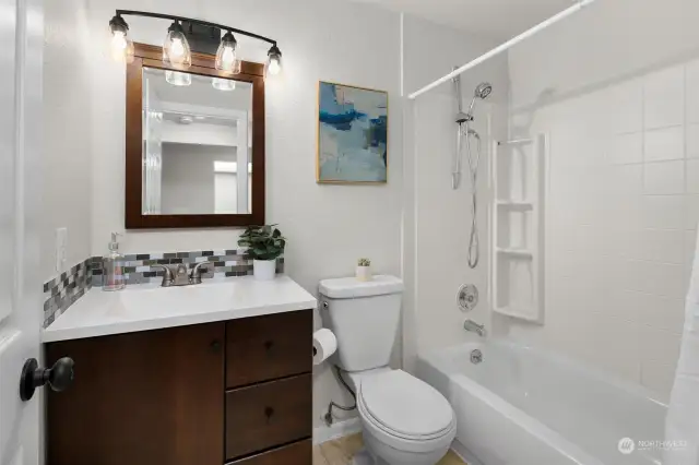 Updated bathroom with newer vanity, new lights, and fresh paint!