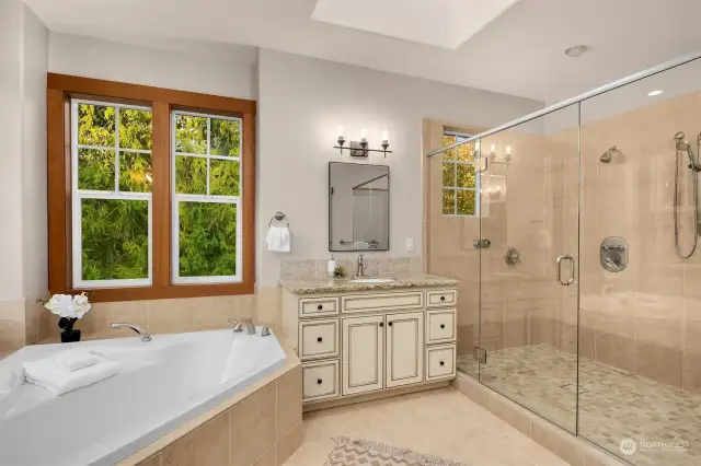 Luxurious primary bath with soaking tub and huge separate shower.