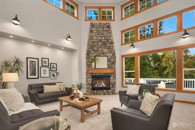 Impressive living room with a soaring ceiling and focal fireplace.