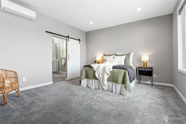 Welcome to the peaceful primary suite! Spacious bedroom, ensuite bathroom with private room for the toilet, and a walk-in closet. Individual ductless unit provides heating and cooling, so you can sleep comfortably on those hot summer nights.