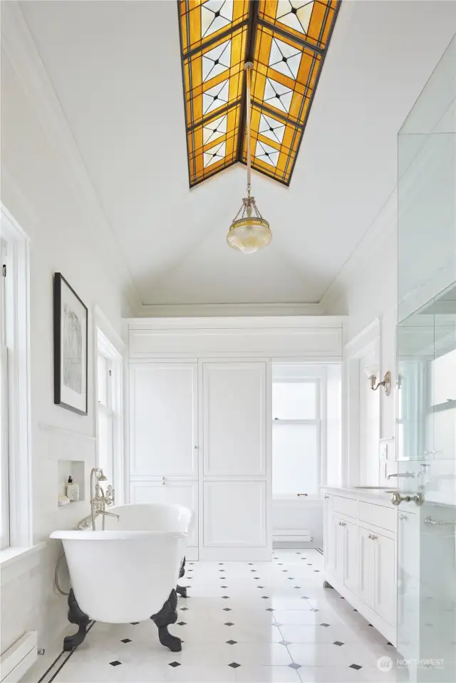 Stunning primary bath was installed in 2017-2018. Designed by Marvin Anderson   Architects, it features spectacular marble floors, a vanity with two sinks, a large walk-in shower, a 6' elegant double-slippered claw-foot bathtub, a private water closet, and a linen  cupboard.