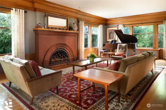 Another vantage point looking north. The large brick fireplace anchors the room.  Note the gleaming hardwood floors and oak trim.The oak hardwood floors were replaced or repaired as necessary to ensure uniformity throughout the home.
