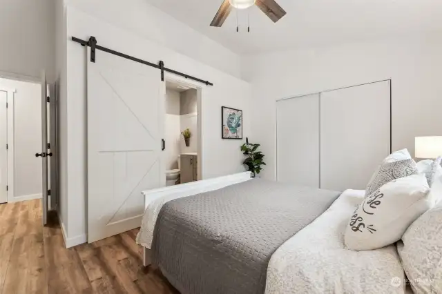 I love the farmhouse rolling door and the new closet doors, this main suite is serene and spacious and being at the back of the home, quiet too!