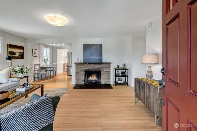 A spacious living area with the original wood-burning fireplace welcomes you home.