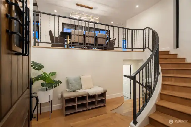 Gracious entry way with sweeping staircase up to main living area.