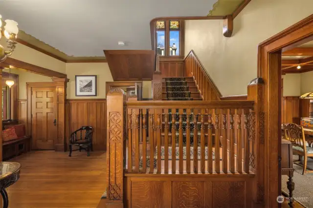 Gracious open staircase to landing with stained glass windows and up to generously sized second level hall leading to four bedrooms, 3 baths and laundry room.