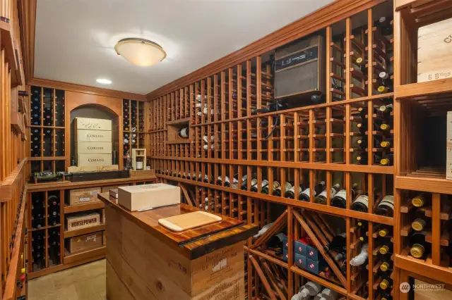 Huge temperature controlled wine cellar with storage up to 1550 bottles in current configuration. Just outside cellar is a wine serving area with sink and undercabinet cooler.