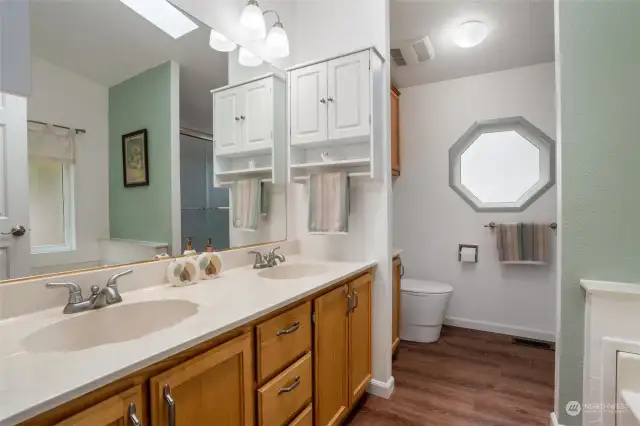 The primary bath has a walk-in Bath Fitter shower, soaking tub, newer toilet, and double vanity.