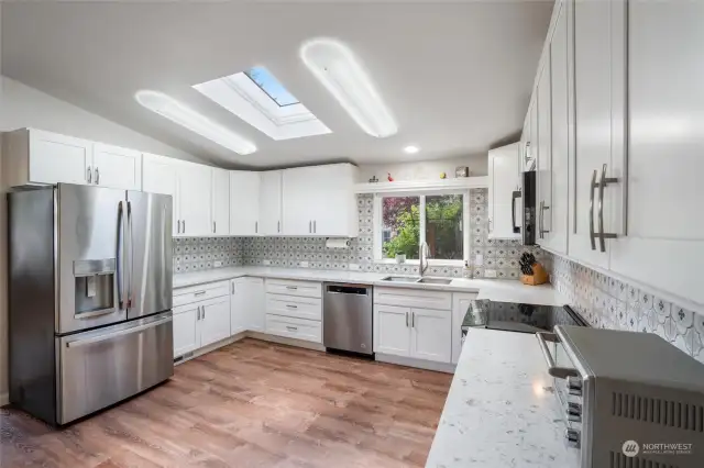 Prepare to be dazzled by the newly remodeled kitchen! Gorgeous quartz counter tops, stainless steel appliances, pristine white cabinetry with soft-close drawers, vinyl plank flooring, all combine to create a chef's delight. The light and bright kitchen will make you feel right at home.