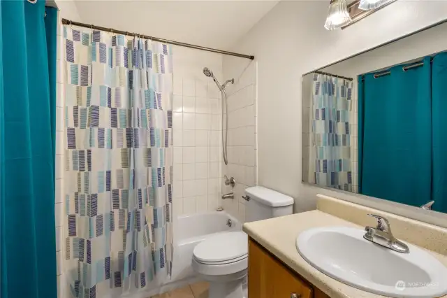 Guest bathroom with new shower curtain, lighting, and fresh paint
