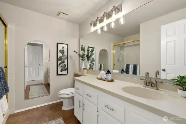 Primary bath has been recently updated and offers great counter space + walk-in shower.