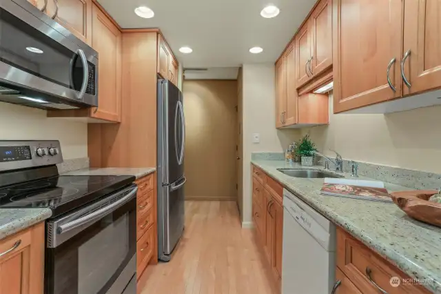Remodeled kitchen has attractive granite counters, upgraded appliances and Maple cabinetry