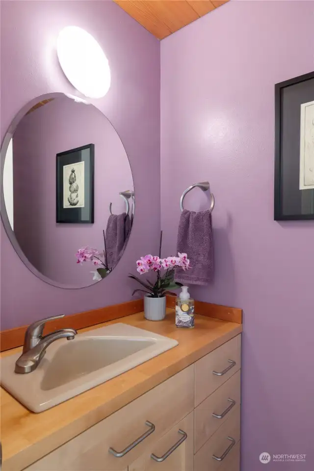 Step into the fun and cheerfully decorated powder room, adding a playful touch to your home's ambiance.