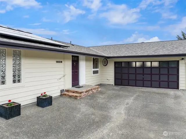 Enjoy the convenience of an oversized two-car garage and ample parking just off the private drive, providing plenty of space for guests.