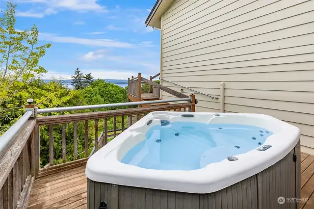 Unwind in the hot tub, nestled amidst breathtaking gardens, offering a private oasis of relaxation.