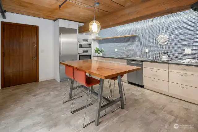 High-end Bosch appliances, quartz countertops and penny tile backsplash complete the beautiful kitchen.