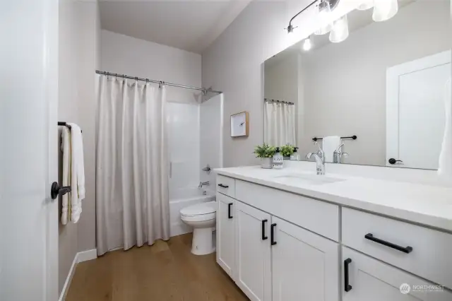 Main bath with LVP floors, taller cabinets and a taller toilet.