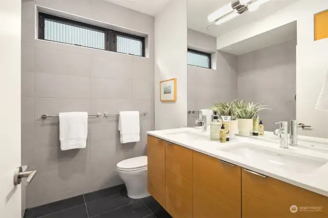 Upstairs bathroom features refined,uniform finishes found through home