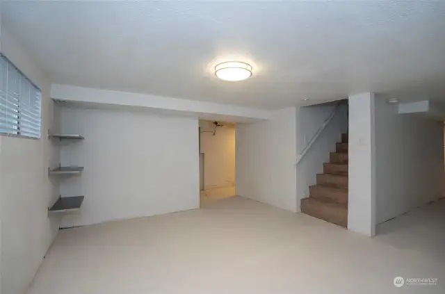 Down the steps across from the main level bathroom is stairs to the large basement