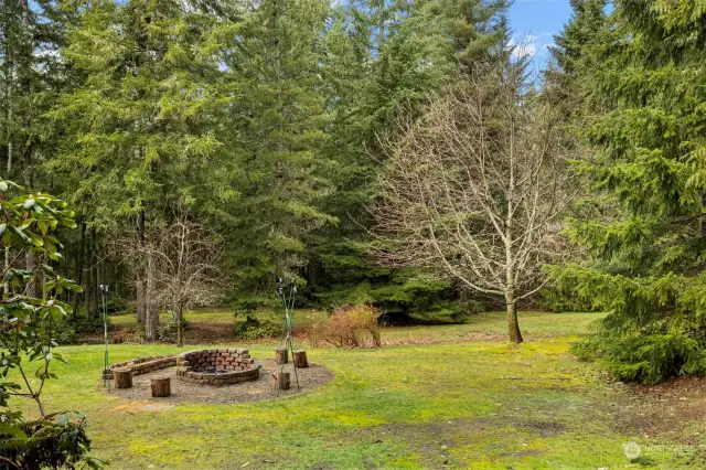 Enjoy privacy, fruit trees, grapes, berries and an 18 foot fire pit area