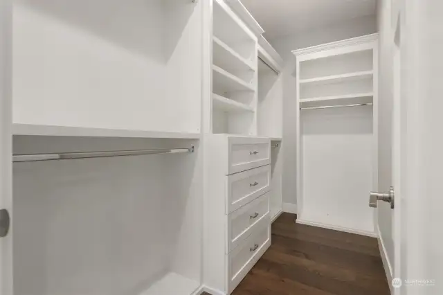 The primary’s closet offers thoughtfully-selected built-in storage.