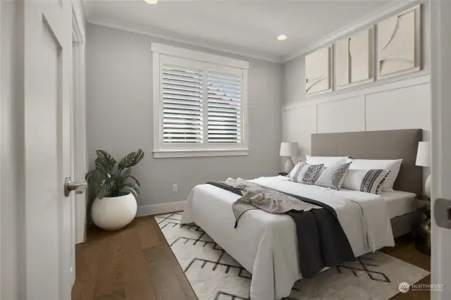 The middle bedroom’s wainscoting provides a gorgeous backdrop for a larger headboard (virtually staged). This room also provides a walk-in closet, with its door just visible on the left of this frame.
