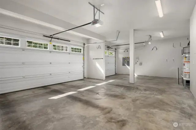 The 3-car garage, in exceptional condition, is fully drywalled. Here, you’ll find the homes TWO high-efficiency hybrid/electric heat pump water heater tanks. The center stall is EV-charger ready (just bring the correct outlet for your car), and the electric panel on the far wall is generator ready (though power outages are not such a big problem in town), and the home is even wired for a solar panel array. The roof sees great souther exposure!
