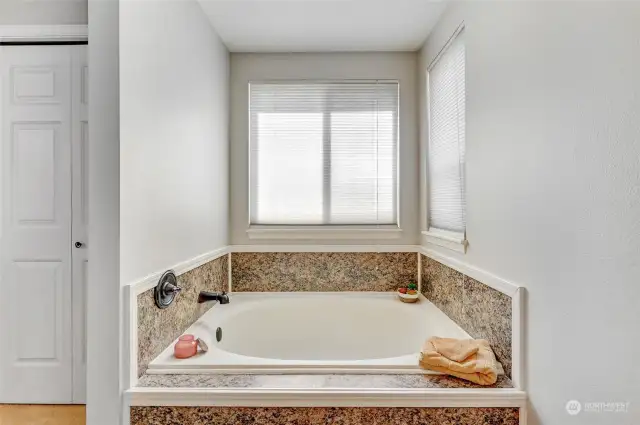 The primary bedroom features a luxurious soaking tub, inviting you to indulge in relaxation and tranquility. With its spacious design and deep basin, the tub provides the perfect retreat for unwinding after a long day.