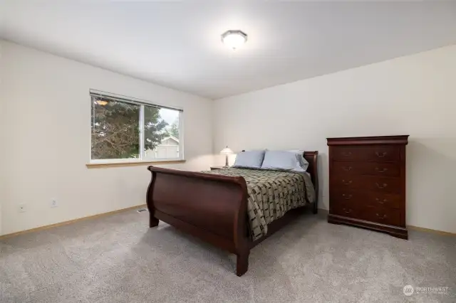 Primary bedroom can easily fit a king-sized bed, or keep this bedroom set, negotiable as part of the sale.  All three bedrooms feature brand-new carpet!