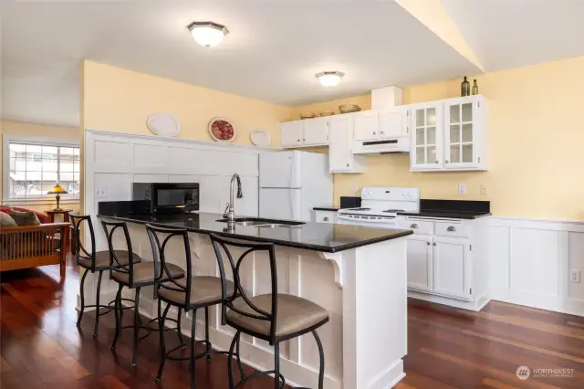 Eat-in kitchen with granite countertops, open to dining and bonus space, perfect for entertaining!