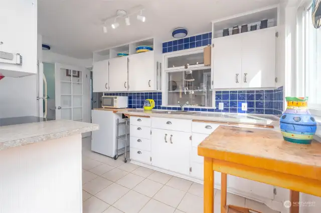 Spacious kitchen, connects the dining/living area and the utility room. The main level bathroom is at the end.