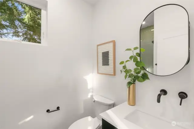 The discreet guest bathroom allows for a smooth separation between primary living & guest hosting!