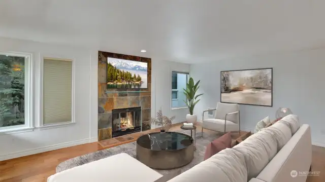 The open floor plan boasts hardwood floors and a  cozy wood-burning fireplace.