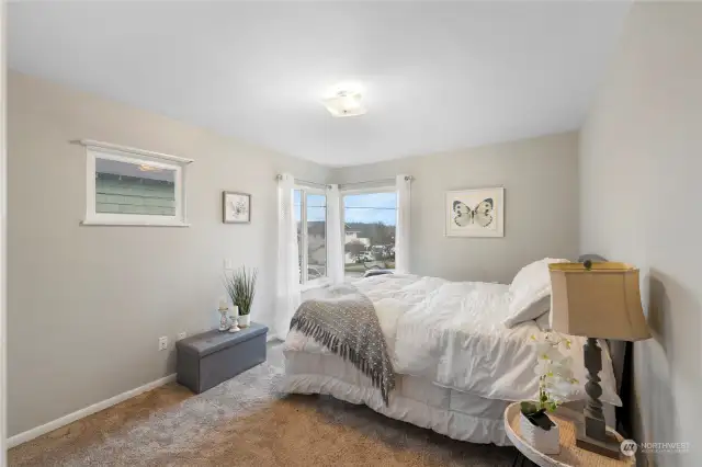 Light and bright, bedroom number one offers views of Mt. Baker, peekaboo water views, built-in closets.