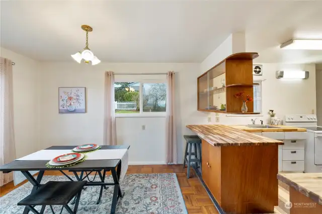 Dining opens to kitchen with adorable mid-century design detail.