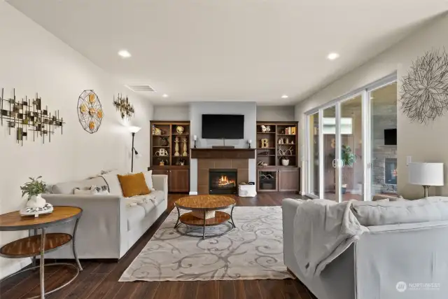 Living room with gas fireplace, built-ins, over-sized sliding door to covered deck