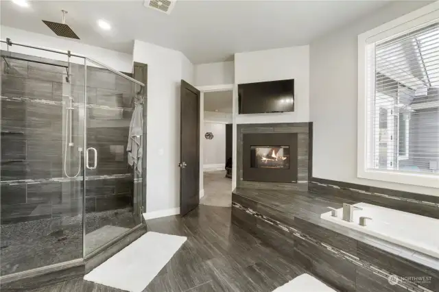 The double-sided fireplace enjoyed while soaking in a bath. The rain shower head is a great way to start the day!