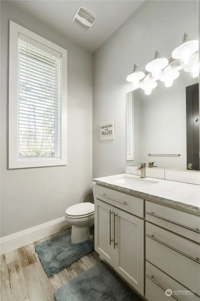 Guest powder room is centrally located.