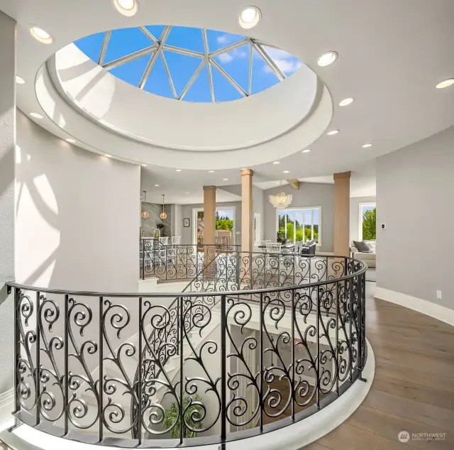 Rod iron railings frame the rounded staircase