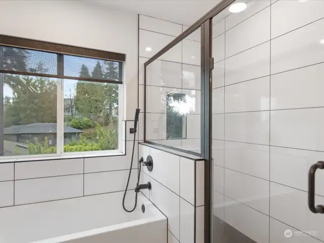 Notice the floor to ceiling tile in the shower. Also features a separate soaking tub.